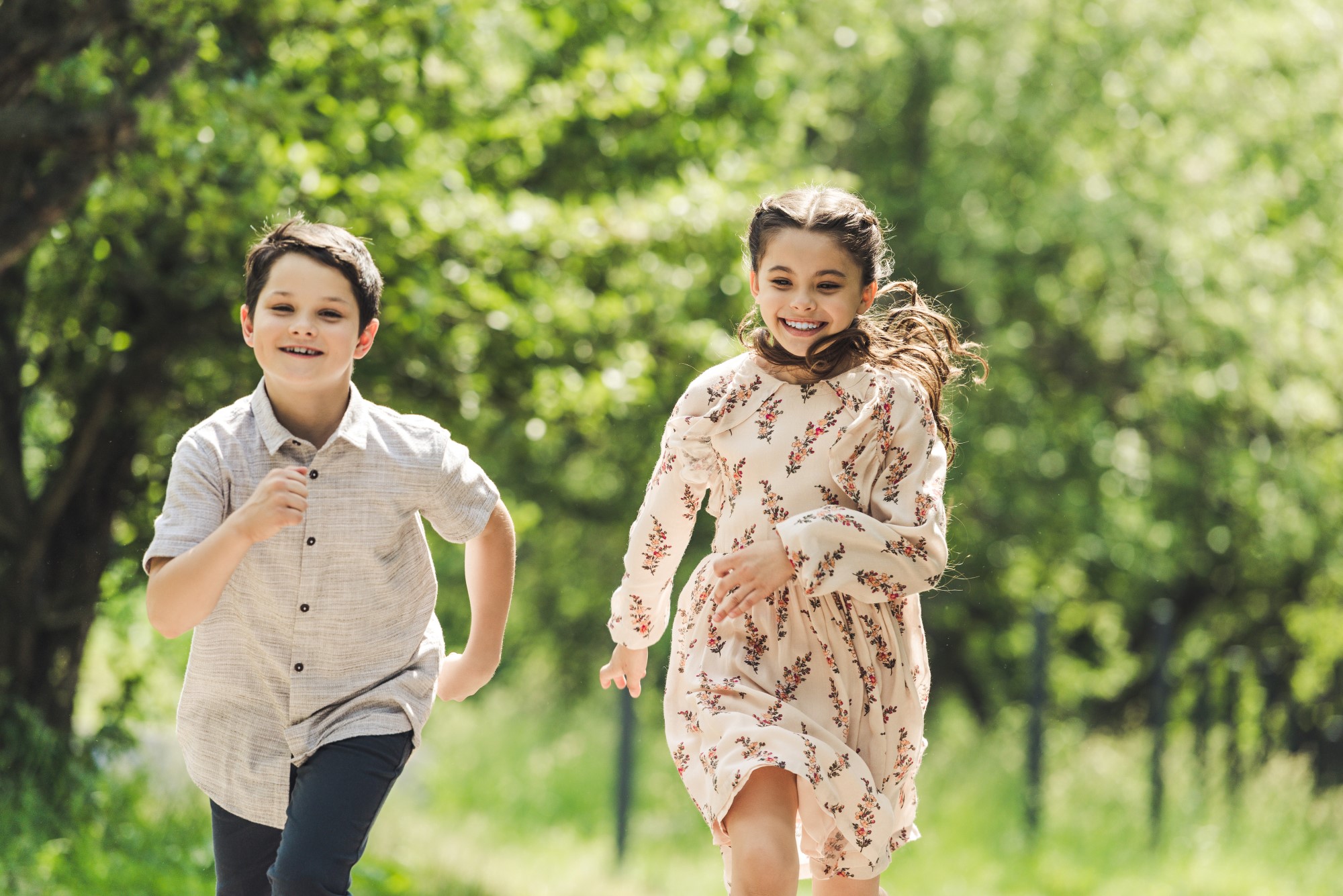 smiling kids having fun and running in summer park