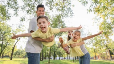 family playing airplane game in park